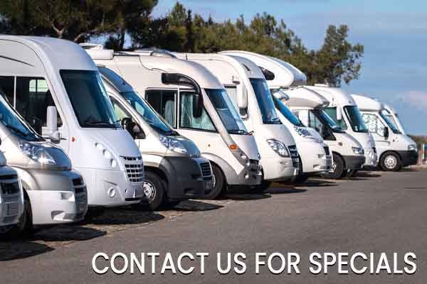 Row of parked RVs under blue sky, with text: Contact us for specials